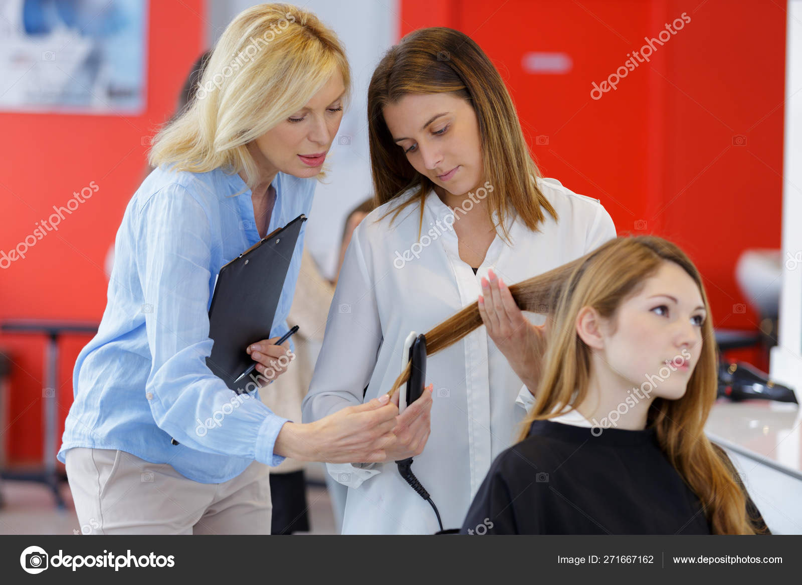 Teacher Helping Students Training To Become Hairdresser Stock