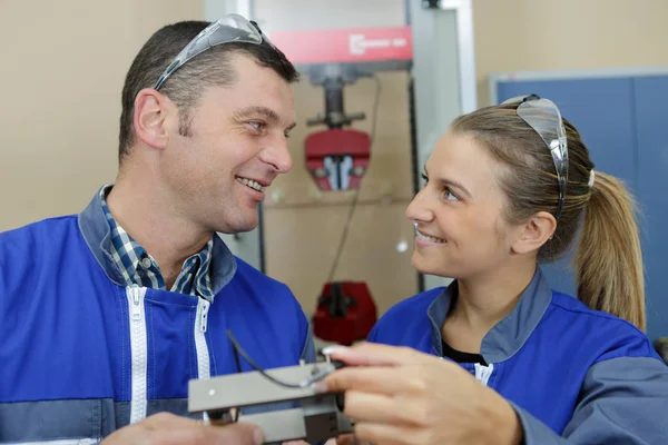 Man and woman work in workshop — Stock Photo, Image