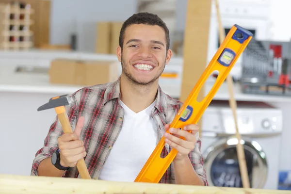 Sonriente trabajador sosteniendo herramientas —  Fotos de Stock