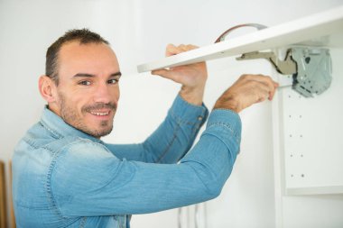 man working on a new kitchen installation clipart