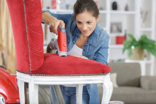 Woman upholstering chair in her workshop — Stock Photo, Image