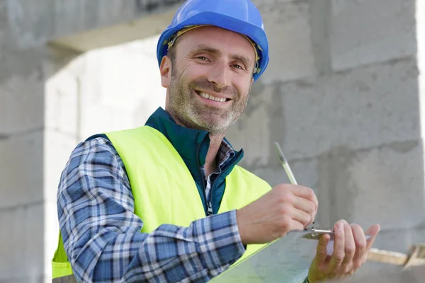 Writing builder with construction tools — Stock Photo, Image