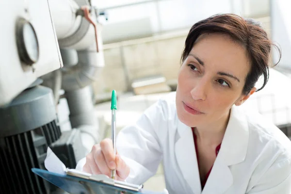 Female consumption factory engineer writing report — Stock Photo, Image
