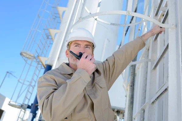 Worker at industrial plant using walkie talkie — 스톡 사진