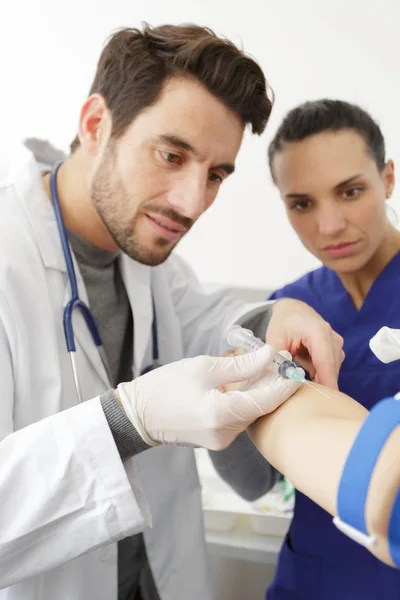 Doctor with an injection needle — Stock Photo, Image