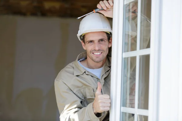 Portrait of a positive worker with thumb up — Stock Photo, Image