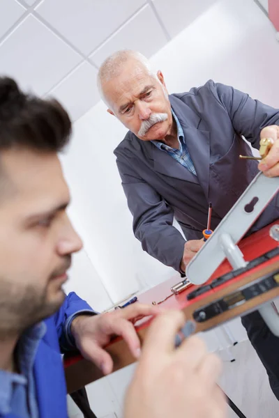 Homens montagem nova fechadura da porta para a porta interior — Fotografia de Stock