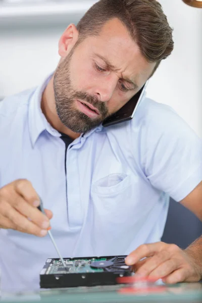 Mannelijke technicus op de telefoon de harde schijf — Stockfoto