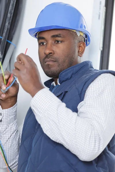 Man installing socket on wall at home — Stock Photo, Image