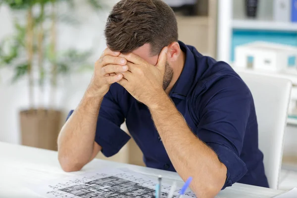 Portrait of architect looking at plans — Stock Photo, Image