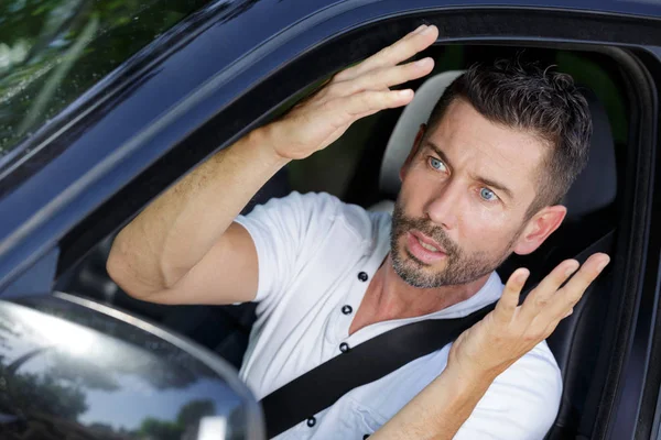 Male driver making gesture of disbelief — Stock Photo, Image