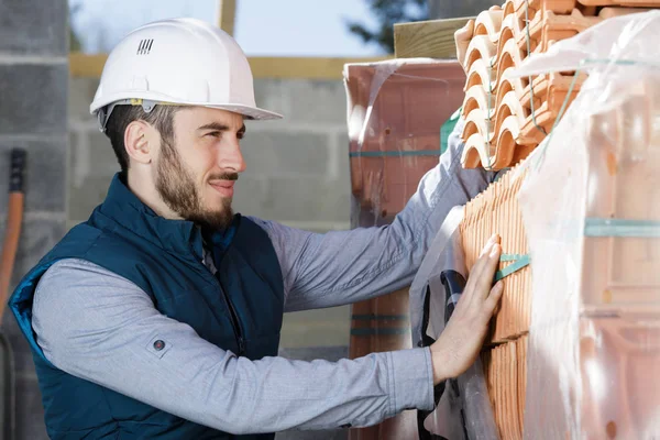 worker builds a brick wall in the