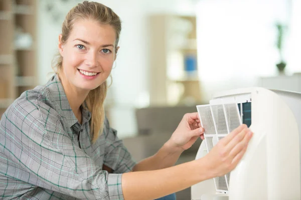 Woman removing appliance filter — Stock Photo, Image