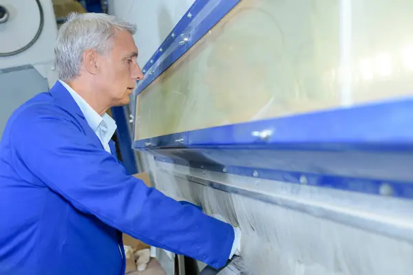 Worker at cabinet hands passed through protective screen — Stock Photo, Image