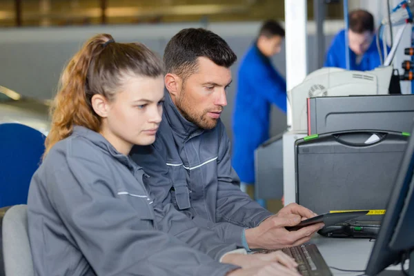 Monteur en leerling werken op computer — Stockfoto