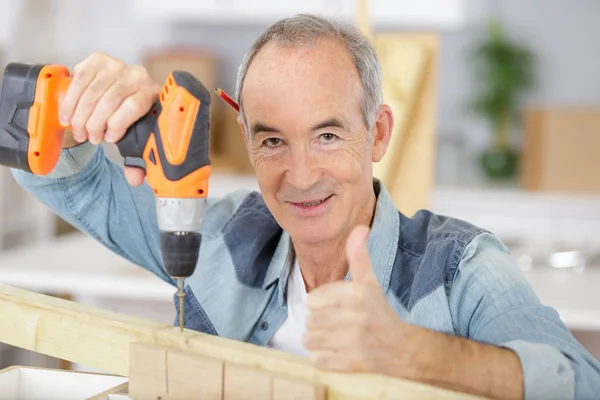 Starszy mężczyzna pracujący nad narzędziami w domu — Zdjęcie stockowe