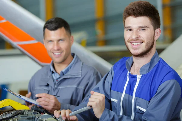 Zwei Männer arbeiten an einer Maschine — Stockfoto