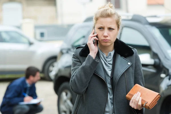 Kvinde ringer bilforsikring udendørs - Stock-foto