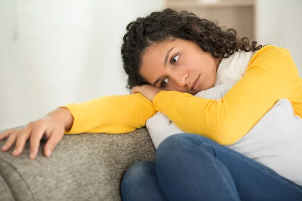 Sad woman locating on comfortable couch — Stock Photo, Image