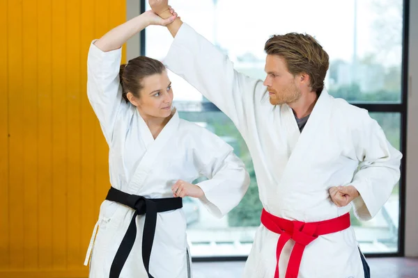 Two martial arts fighters fighting indoors — ストック写真