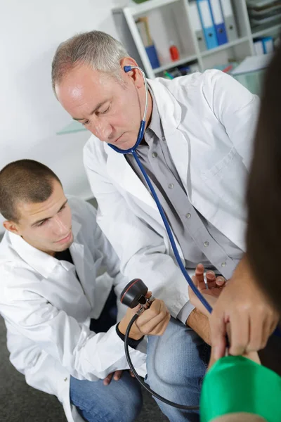 a doctor guiding an intern