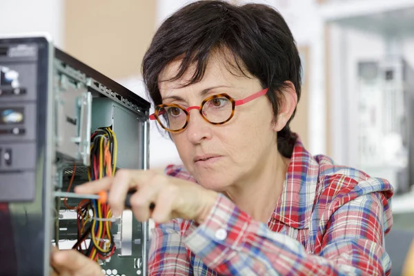 Zralé žena opravit PC komponentu v servisním centru — Stock fotografie
