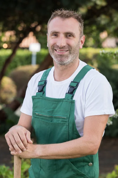 happy gardener with a showel looking at camera