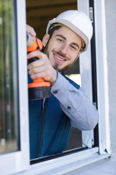 Happy Man Drilling Window Frame — Stock Photo, Image