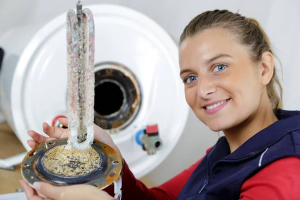 Female Plumber Showing Corroded Heating Element — Stock Photo, Image
