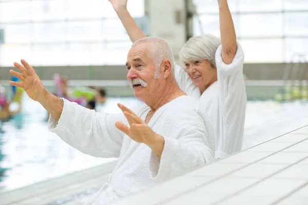 stock image happy elderly couple on a pool deck