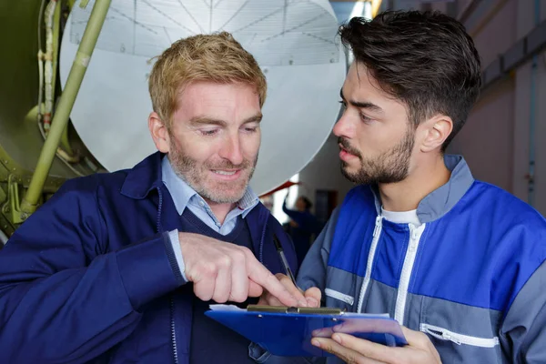 Two Aircraft Assembling Workers Checking Notes — Stock Photo, Image