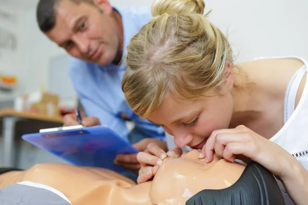 woman in first aid course exercising life-sustaining measures