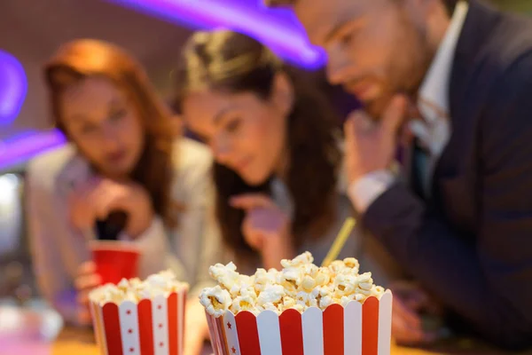 portrait of people and popcorn in the cinema