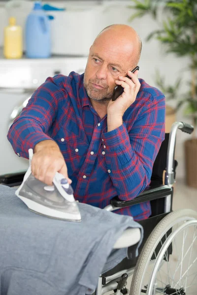 Disabled Man Ironing Clothes Talking Phone — Stock Photo, Image