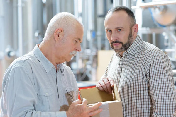 Warehouse Worker Cardboard Box Talking Male Supervisor — Stock Photo, Image