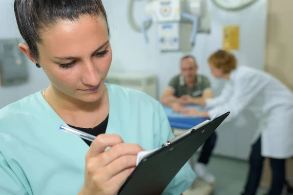 Female Nurse Writing Medical Report Clipboard Hospital — Stock Photo, Image