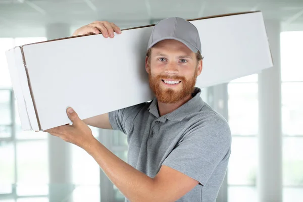 Happy Delivery Man Holding Package — Stock Photo, Image