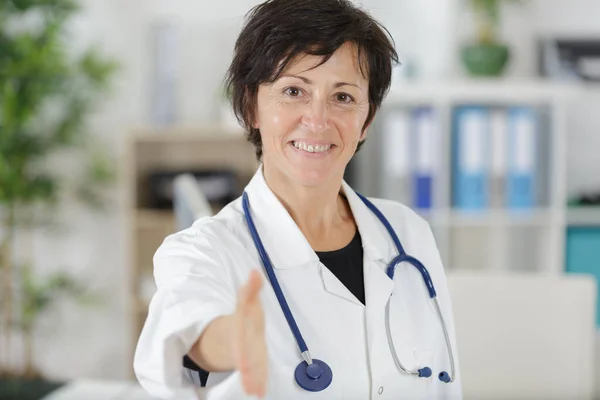 Senior Female Doctor Holding Forward Her Hand Greeting — Stock fotografie