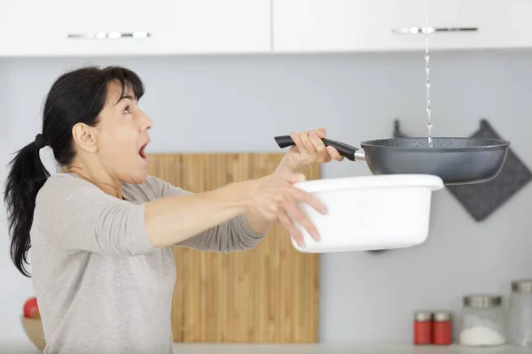 Mature Woman Holding Bucket While Water Droplets Leak Ceiling — Stock Photo, Image