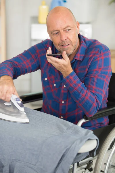 Disabled Man Wheelchair Ironing Clothing — Stock Photo, Image
