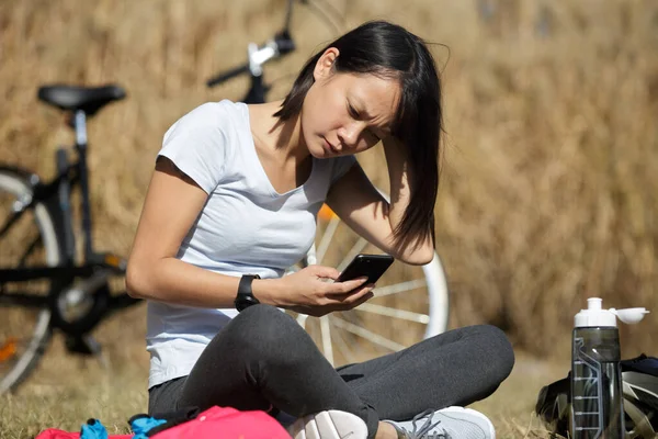 Una Ciclista Femenina Está Relajando Revisando Teléfono Imagen De Stock