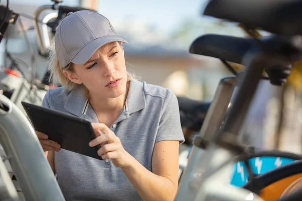 Woman Using Digital Tablet Bicycle Rental Concept — Stock Photo, Image