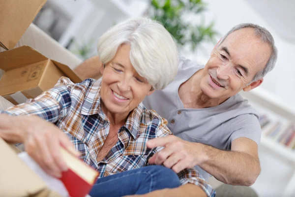 happy senior couple moving into their new home