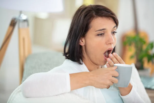 Young Woman Sofa Cup Coffee Yawning — Stock Photo, Image