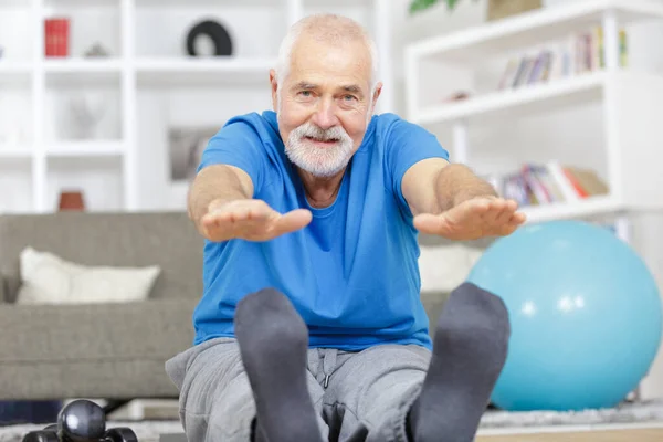 Mature Man Stretching Legs Indoors — Stock Photo, Image