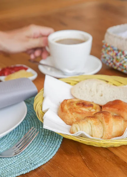 Assorted pastries, coffee and marmalade on the table