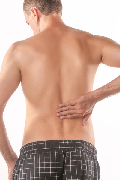 Studioaufnahme Eines Jungen Mannes Mit Rückenschmerzen — Stockfoto