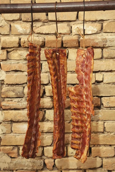 Smoked Meat Hanging Brick Wall Background — Stock Photo, Image