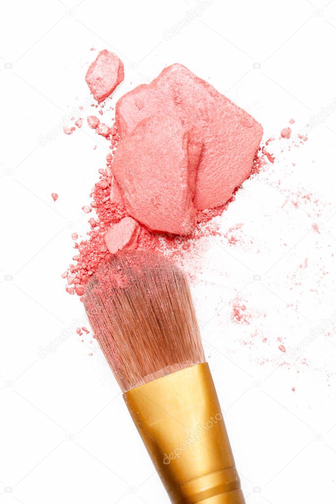 Crushed pink eyeshadow and make-up brush