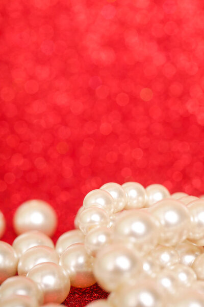 Pile of pearls on red. Pile of pearls on red Christmas background 